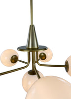 Close-up of Orion Chandelier aged brass frame and milk glass shade
