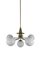Close-up of Orion Chandelier aged brass frame and milk glass shade
